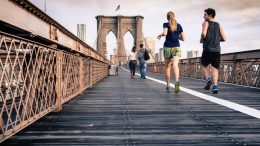 people jogging on bridge